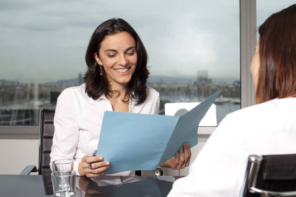 Recruiter checking the CV during job interview