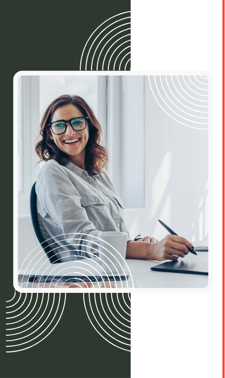Suddenly self-employed? Get back to work — fast. Professional woman with glasses at a desk, holding a pen.